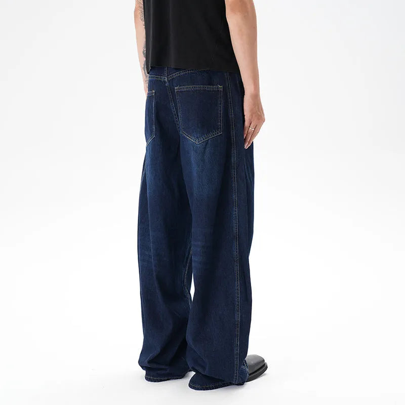 Dark blue washed distressed wide leg machete jeans showing denim fabric texture and wide leg silhouette