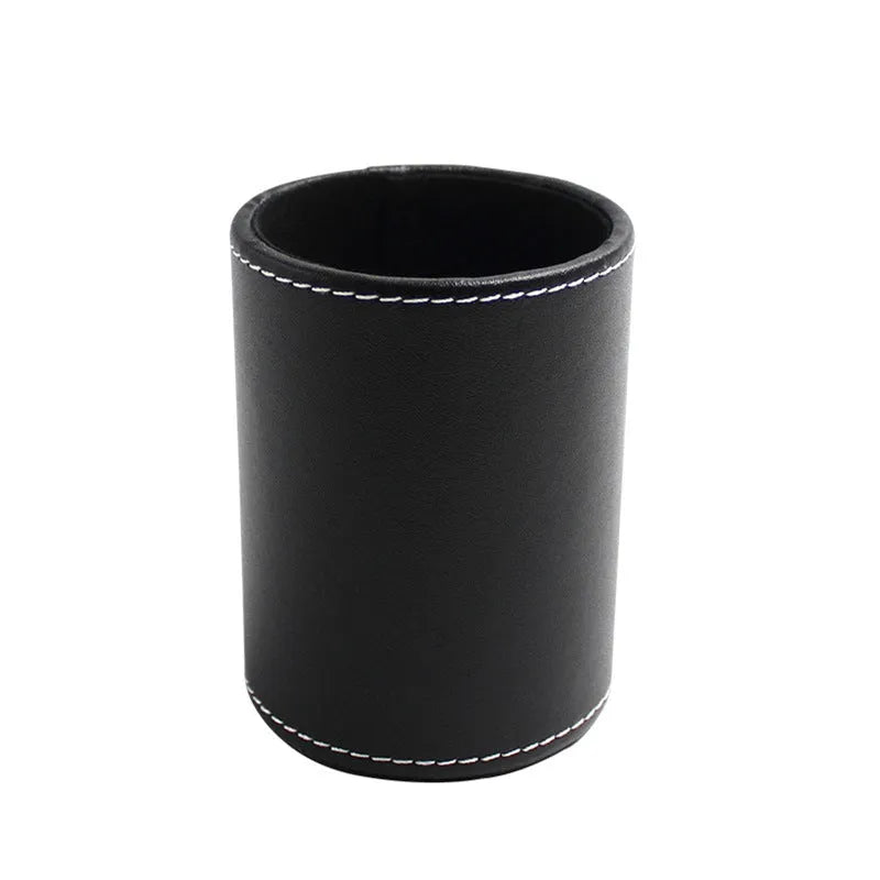 Small round black leather pen container for desk organisation.
