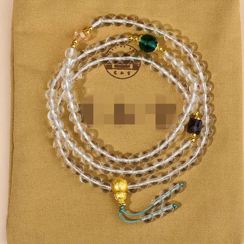 White crystal 108-bead rosary necklace and matching bracelet set on a plain background