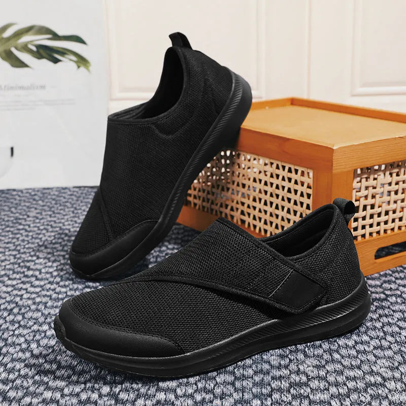 A pair of casual walking shoes with a mesh upper and Velcro strap closure, shown in one of four available colours.