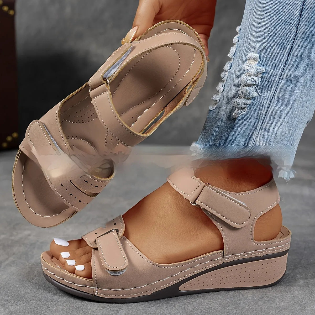 Women's beige thick-soled sandals with adjustable black Velcro straps on a white background.