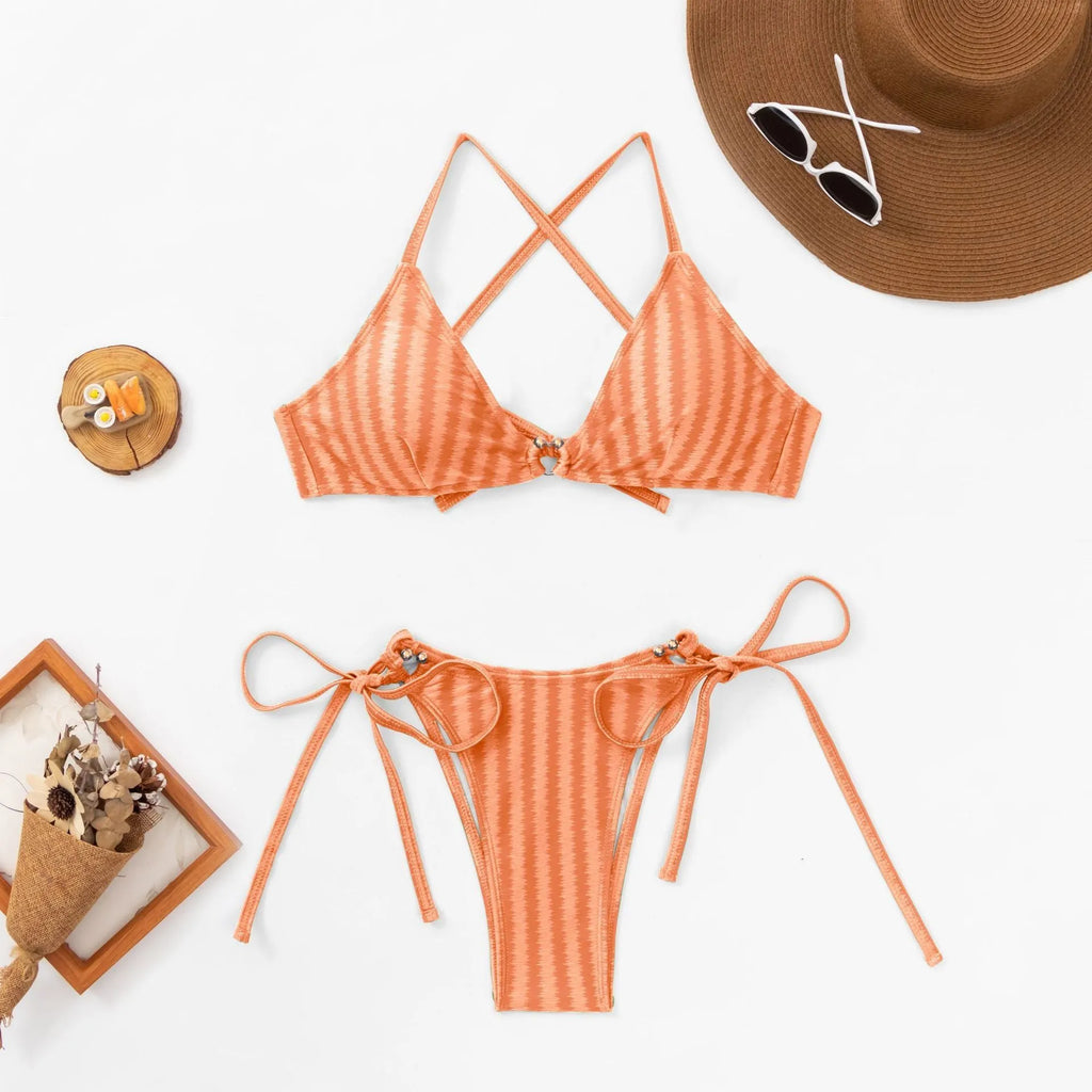 Women's red lace-up bikini top and matching split briefs on a mannequin.