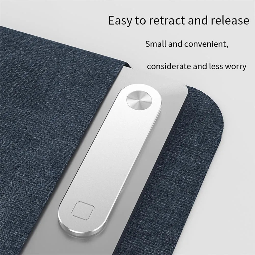 Black magnetic phone holder attached to side of silver laptop, showing phone mounted.