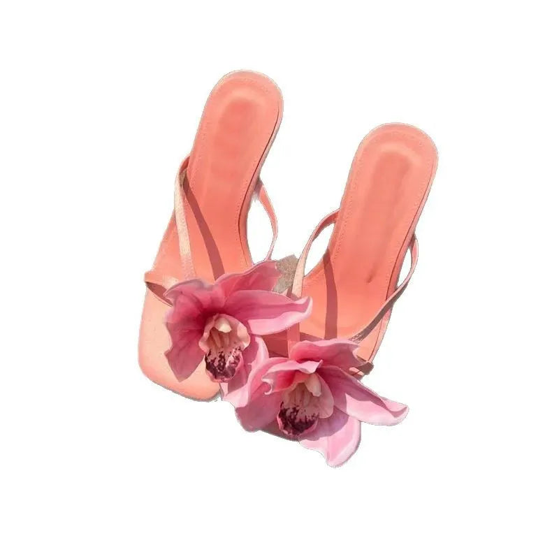 Pink satin women's high heel sandals with a square toe and a white artificial flower decoration.