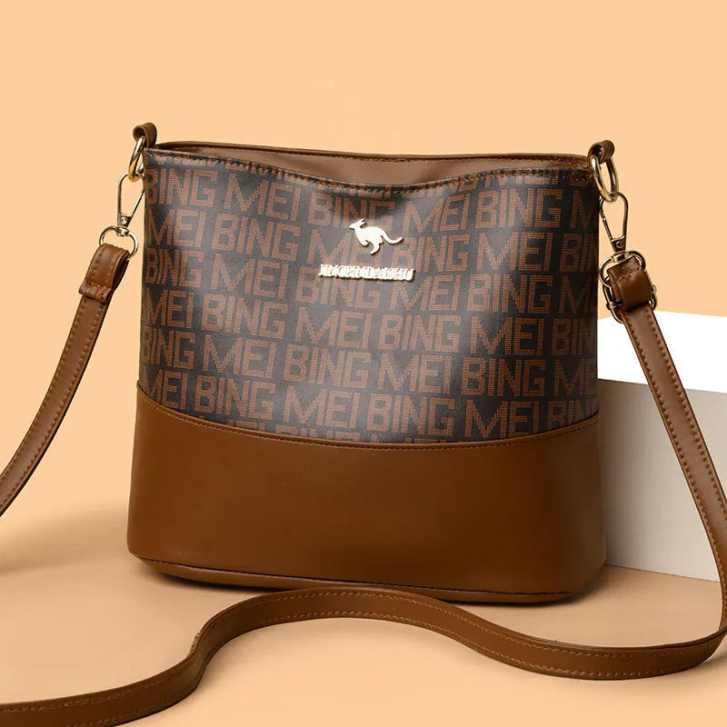 Brown soft PU leather messenger bag with external pocket and organised interior compartments.