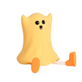 Ghost shaped silicone bedside lamp with touch control emitting soft yellow glow on a bedside table