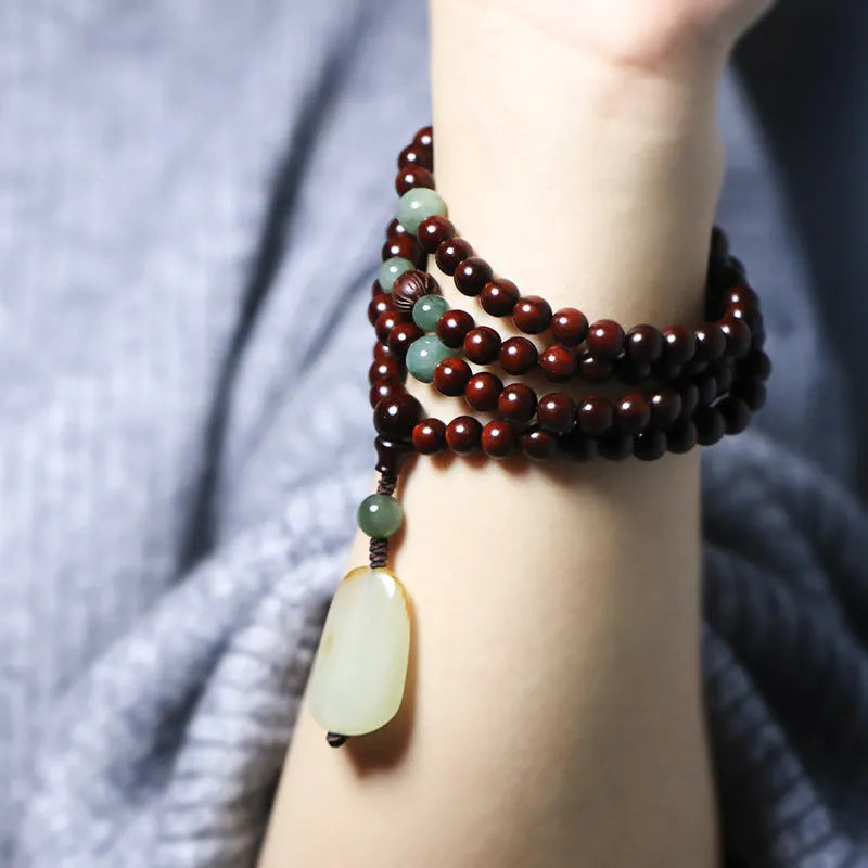 Rosewood bead bracelet with a carved Pterocarpus Santalinus and Hotian Jade stone pendant.