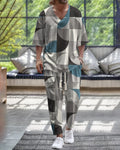 Lightweight polyester trousers suit with cropped sleeve V-neck jacket on a hanger.