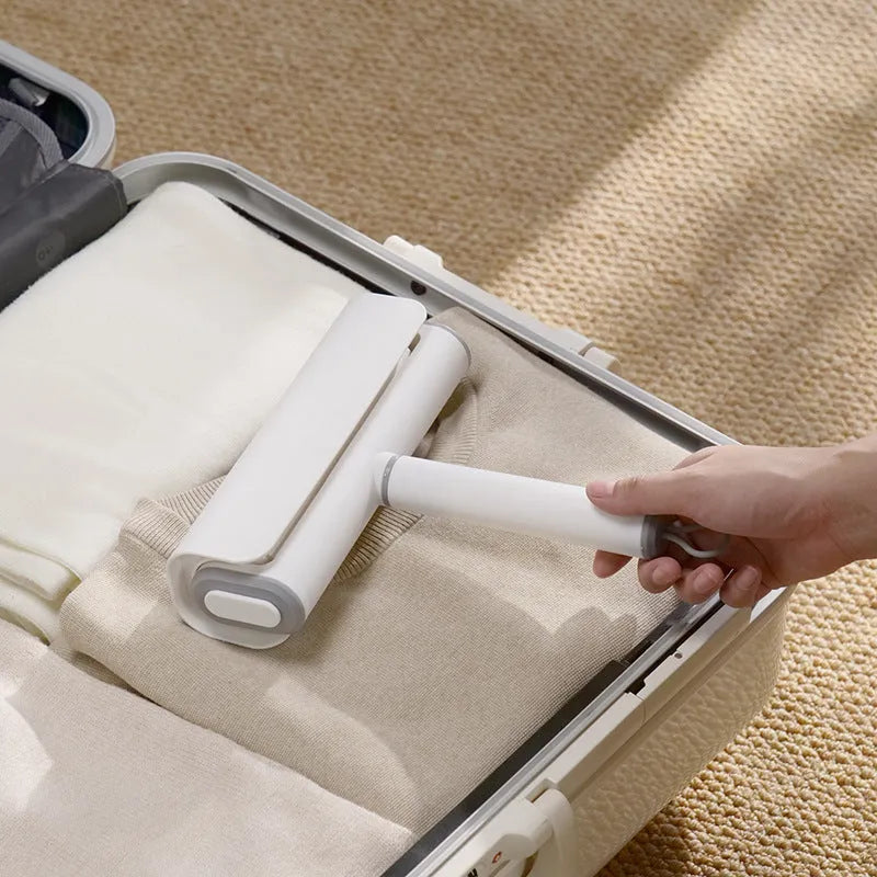 Handheld lint remover roller with tearable paper stick for removing pet hair from floors and furniture