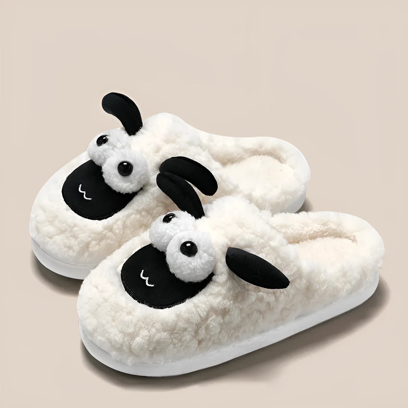 Brown suede slip-on slippers with a PVC sole on a wooden floor.