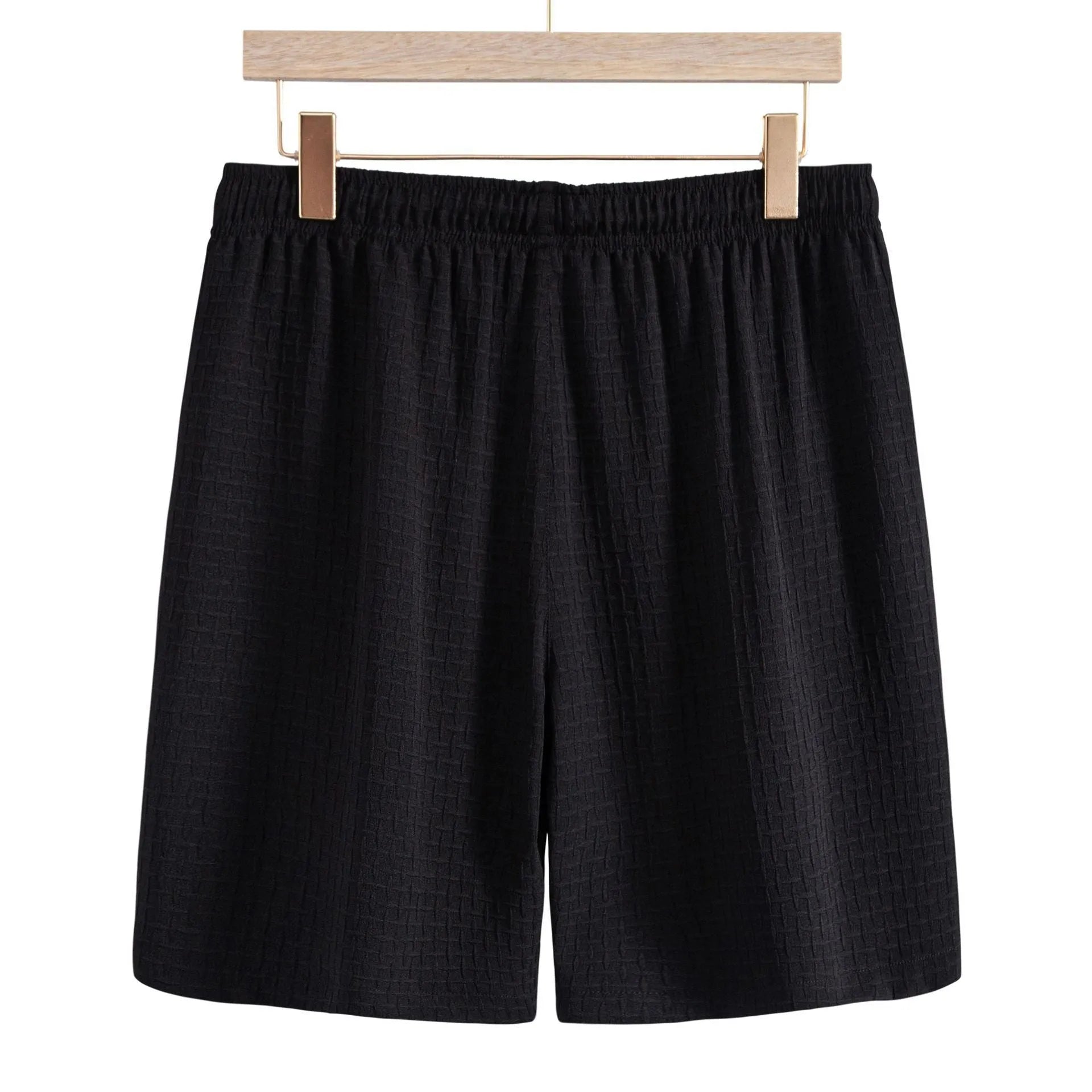 Men's white cotton blend beach suit with short sleeve shirt and loose-fitting shorts on a hanger.