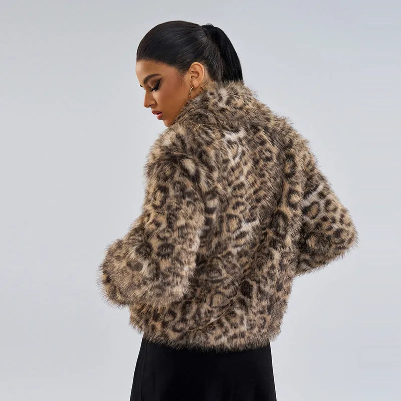 Women's leopard print coat with a buckle on the lapel collar, shown in street fashion style.