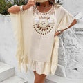 Crochet stitch detail on a patchwork skirt beach dress swimsuit cover-up in apricot colour.