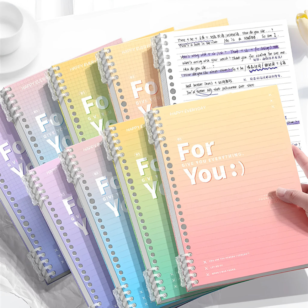 Removable coil gradient notepad in blue, green, pink, or purple with grid paper.