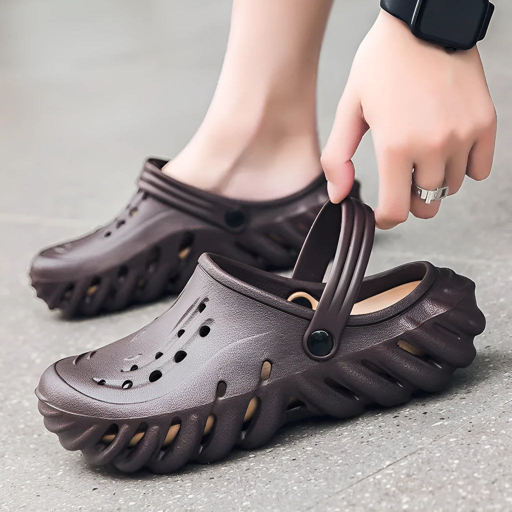 Men's beige EVA hole shoes with breathable holes and a strap, shown on a foot.