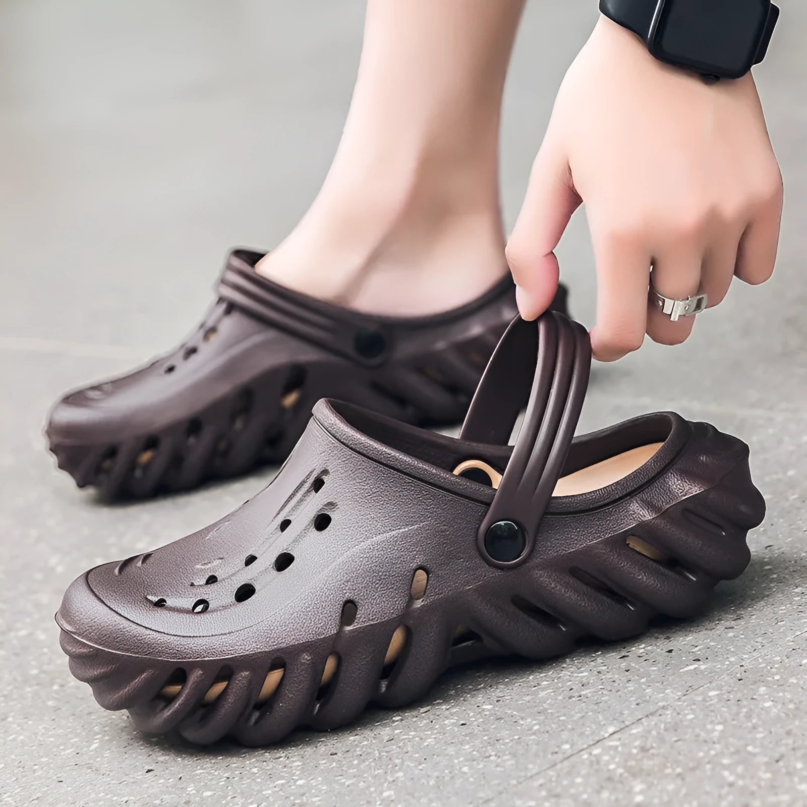 Men's beige EVA hole shoes with breathable holes and a strap, shown on a foot.
