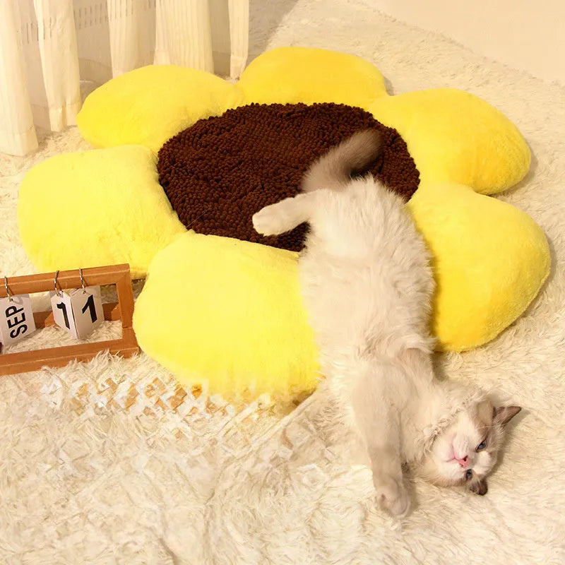 Round blue cat bed with high plush walls and soft filling, shown on a wooden floor.