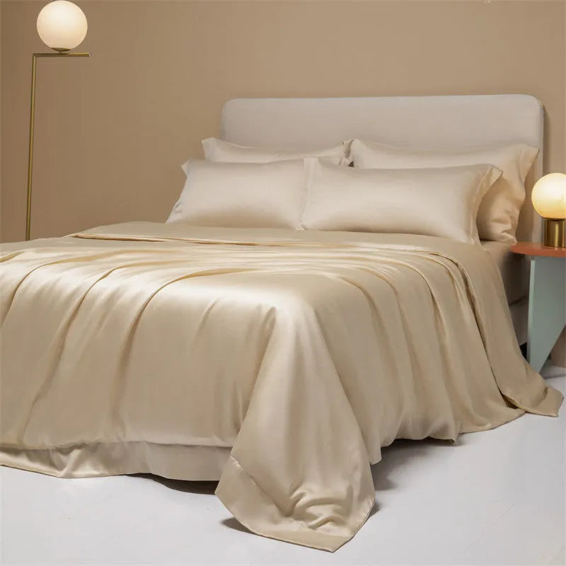 Aurora Blue 200 thread count Tencel duvet cover, fitted sheet, and pillowcases laid on a modern bed.
