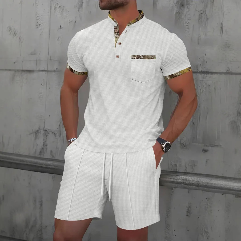 Men's grey zip-up polo collar short sleeve top and shorts tracksuit set laid flat.