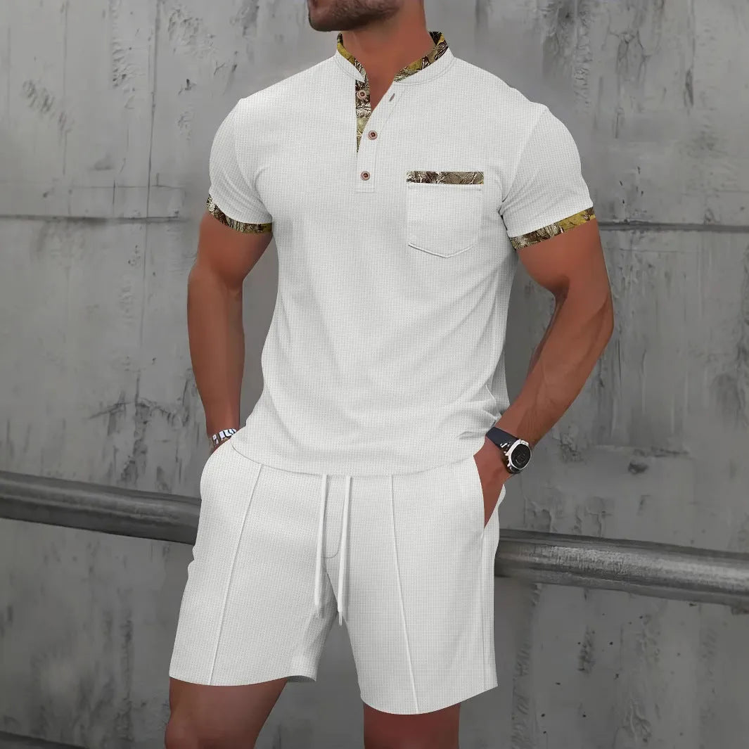 Men's grey zip-up polo collar short sleeve top and shorts tracksuit set laid flat.