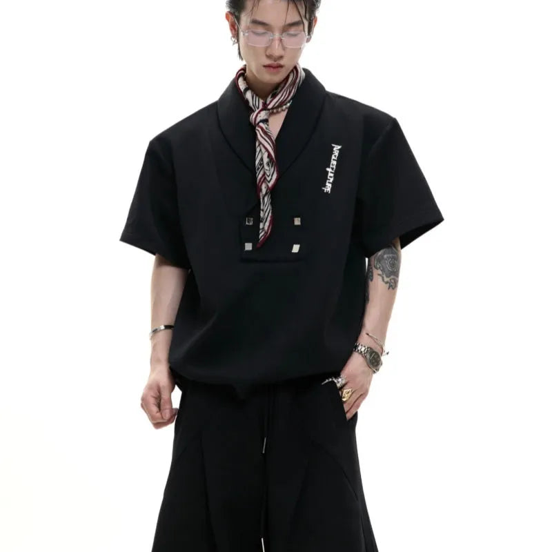 Men's dark grey V-neck sports suit with padded shoulders, metal details, and cotton shorts laid flat.