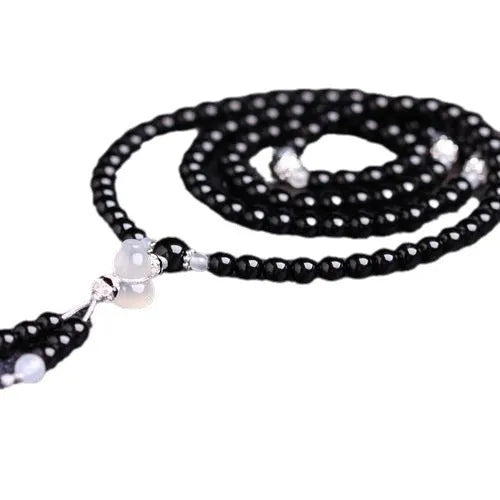 Natural red and black agate 108 bead prayer bracelet with geometric shapes.