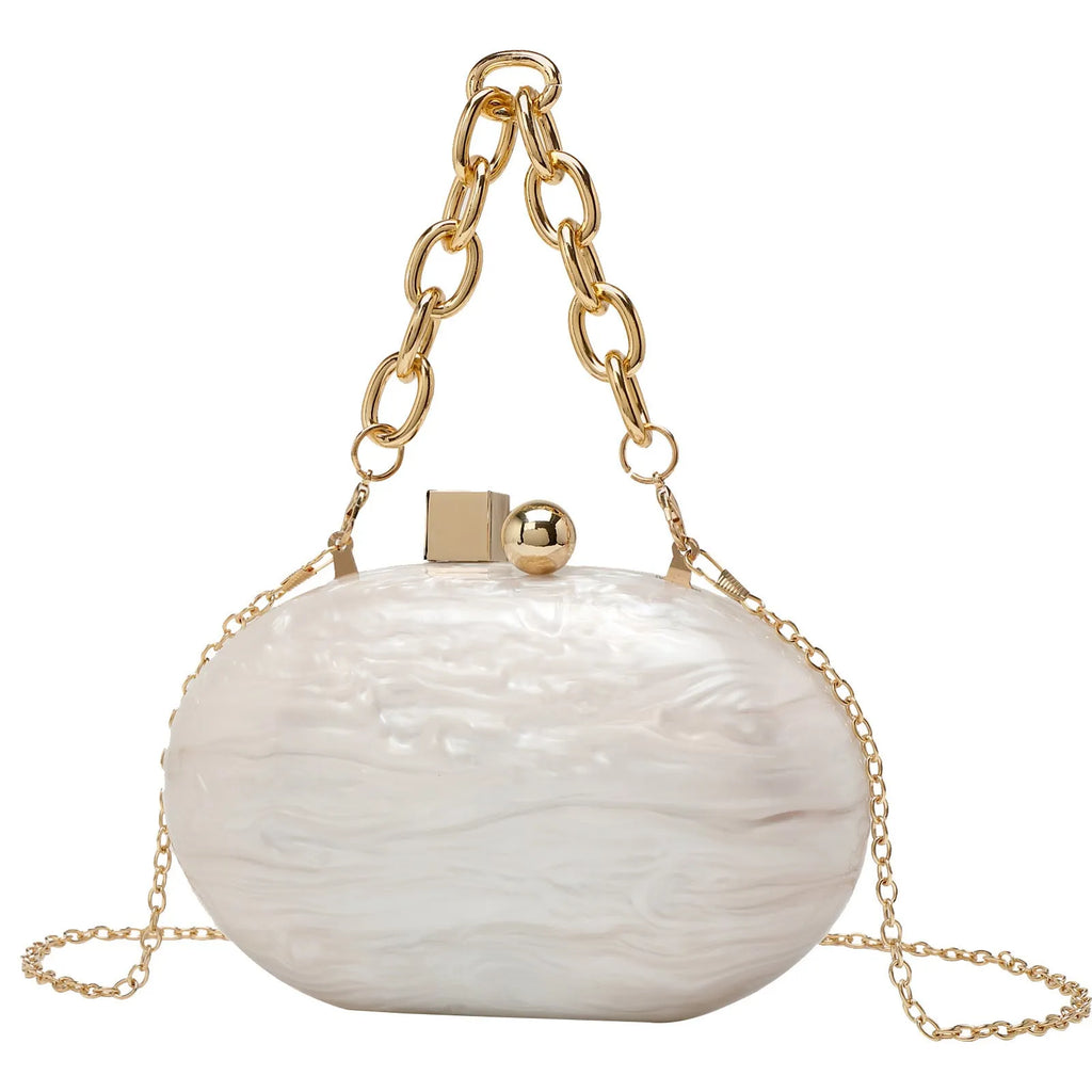 Hard acrylic oval clutch bag with chain strap in a pearlescent colour with phone and file compartments visible.