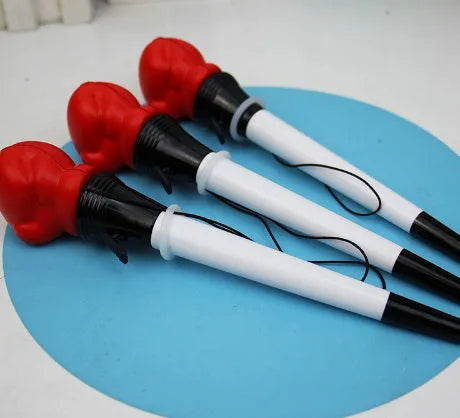 Set of four black creative pressure relief pens with boxing figure press-to-eject mechanism.