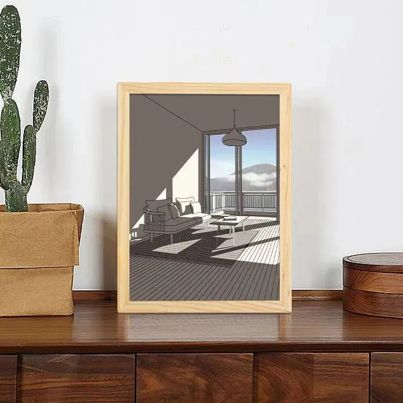 LED illuminated decorative picture light on a bedside table showing a sunny landscape scene.