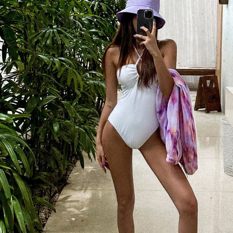 White one-piece swimsuit for women with backless design and hollow-out covering belly detail