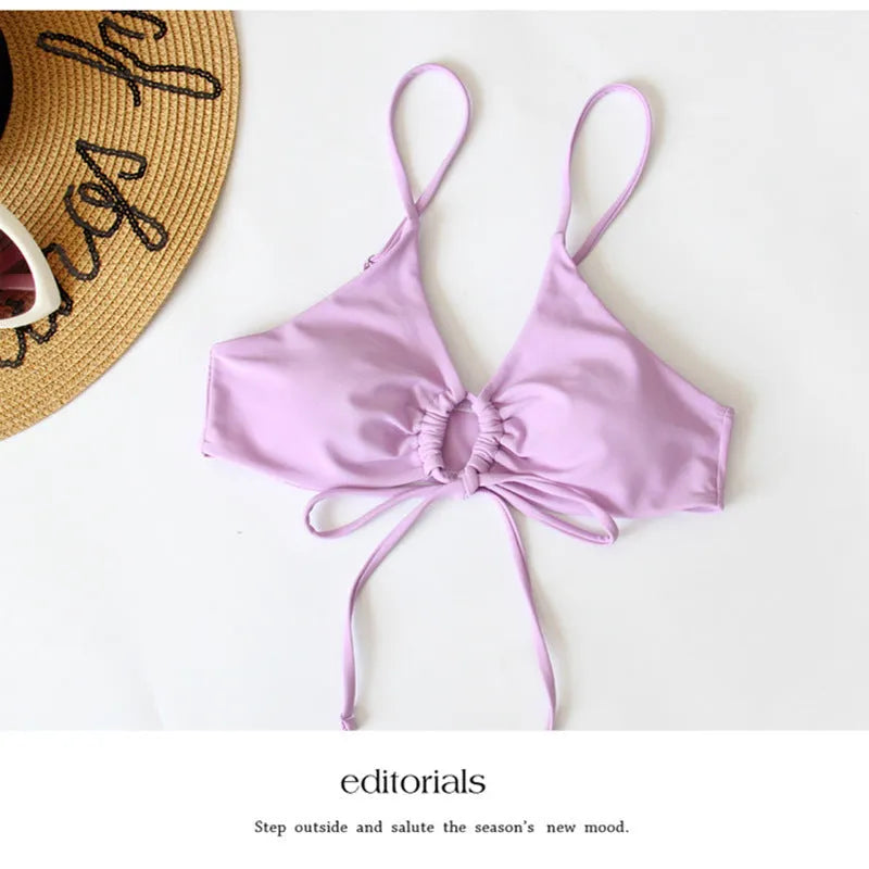 Women's orange tied bow bikini with split brief style on a mannequin.