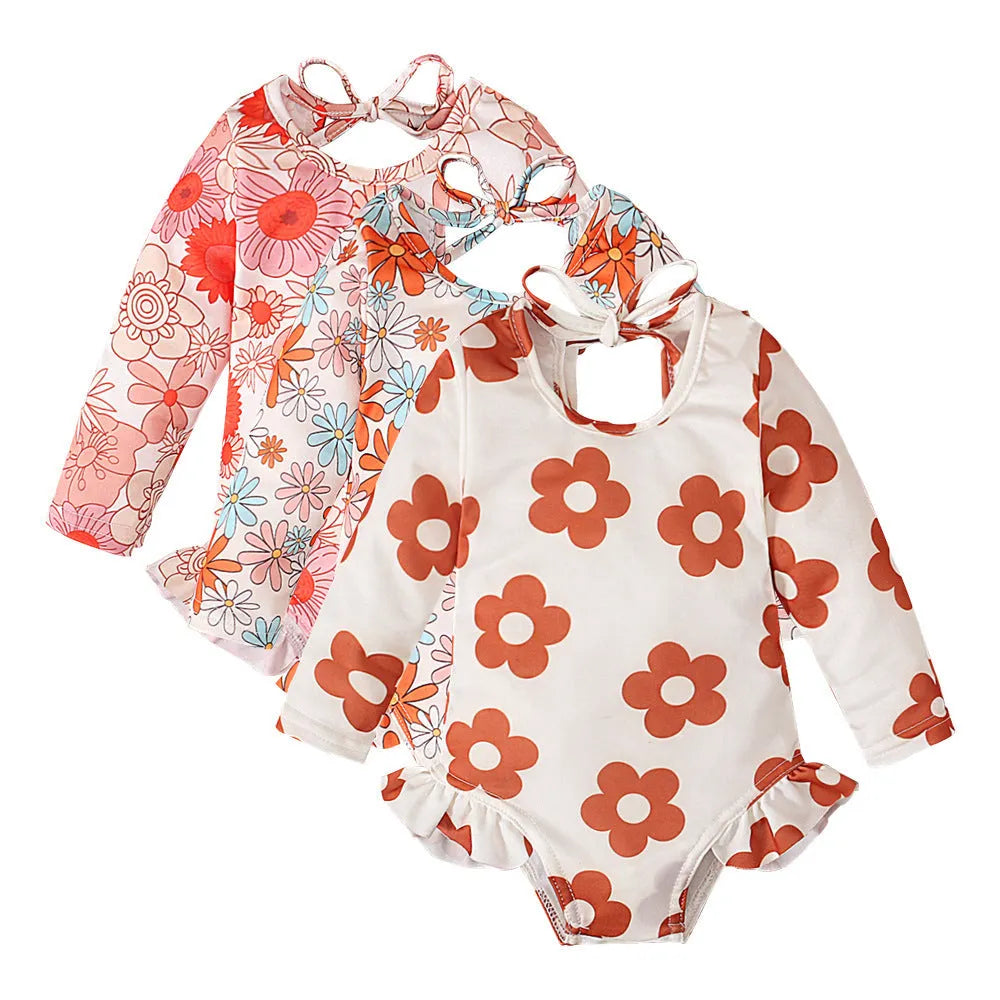 Girl's white floral print one-piece swimsuit with crew neck and open back design