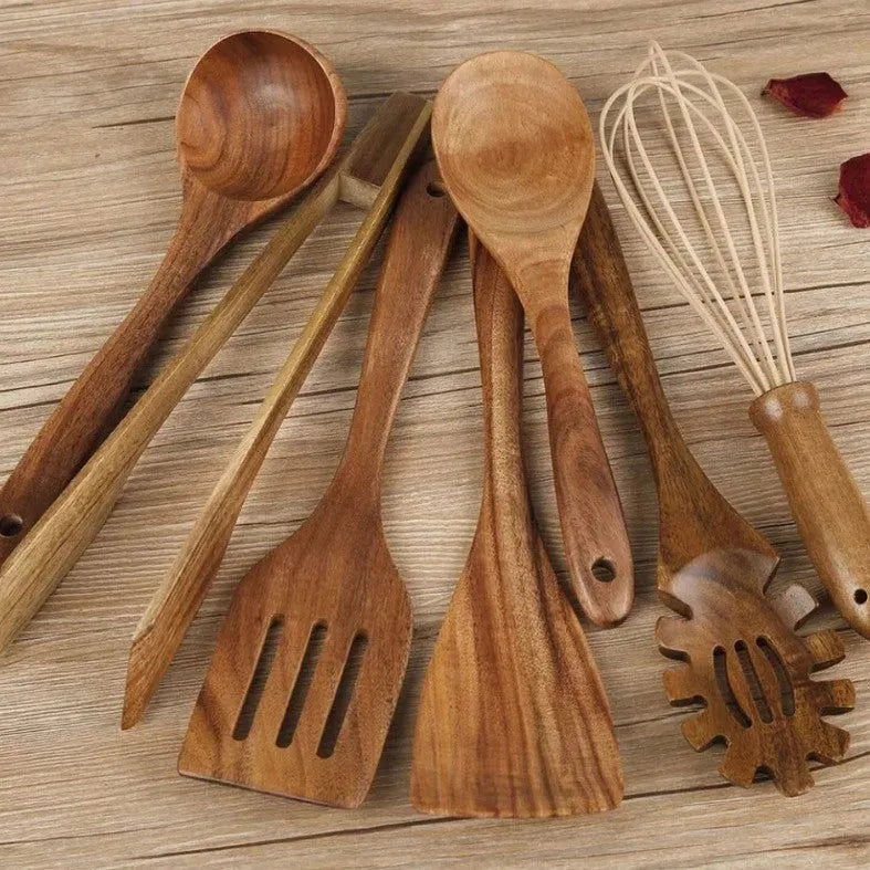 Seven wooden cooking utensils including spoons and spatulas arranged together