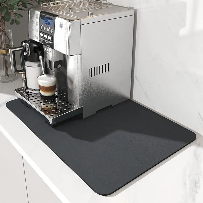 Black square absorbent drain pad mat with PU leather surface on a kitchen countertop