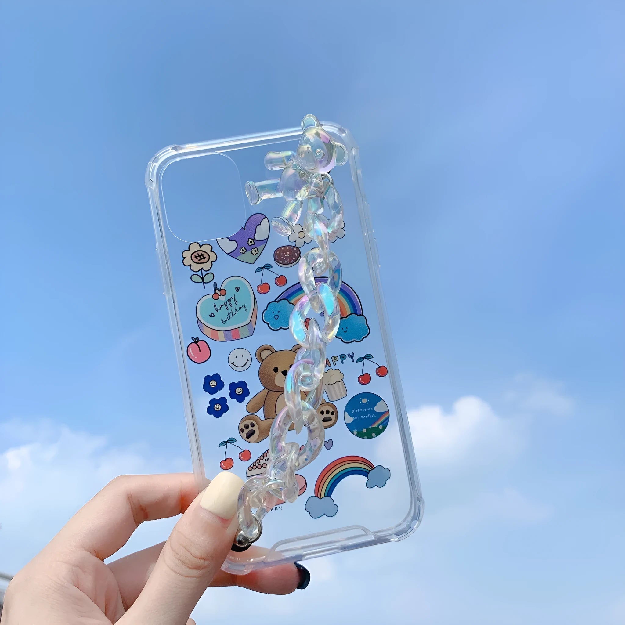 White TPU iPhone case with an attached silver bear pendant on a chain, showing cartoon-style design.
