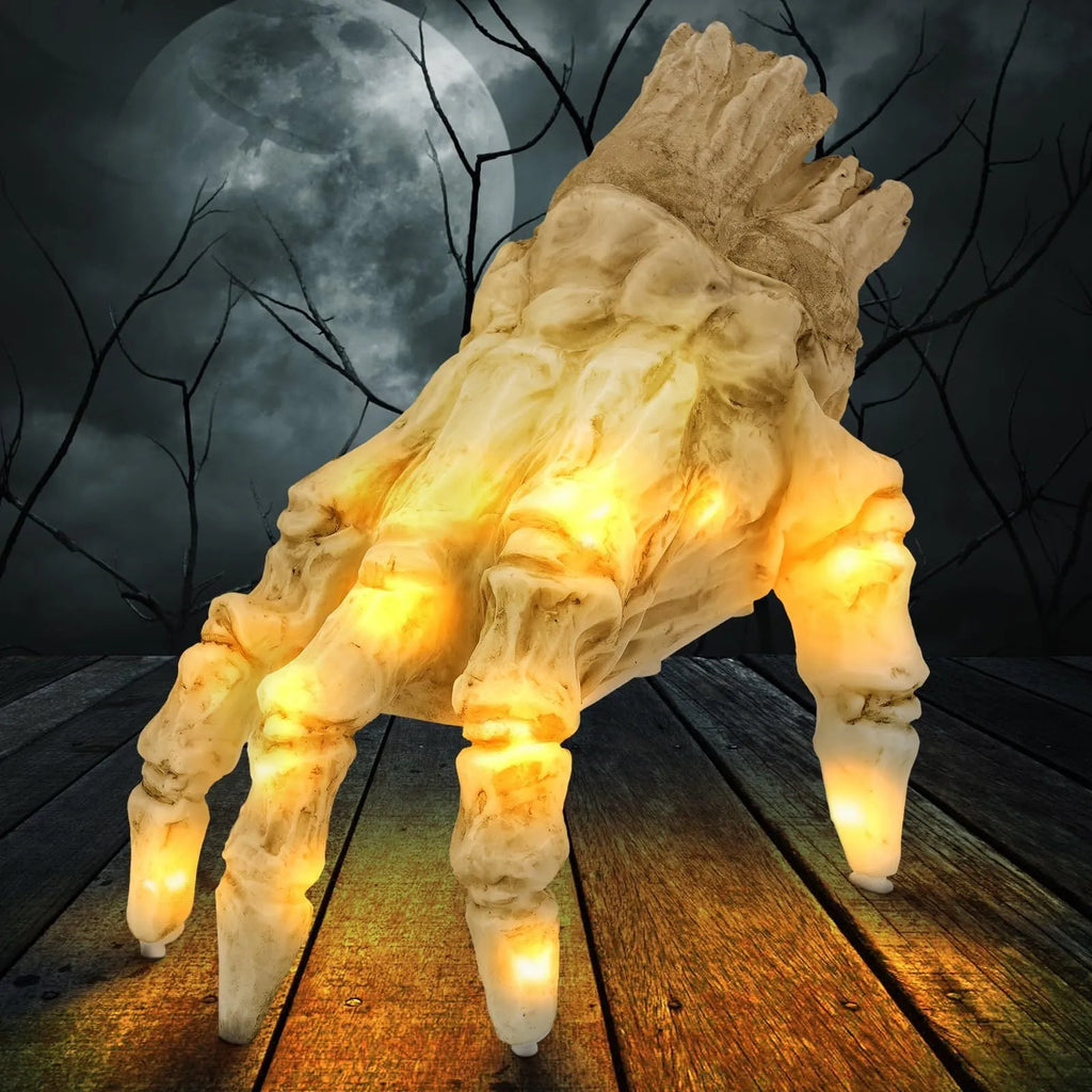 Halloween electric luminous crawling hand on floor, glowing warm colour, vinyl zombie hand with spooky sound