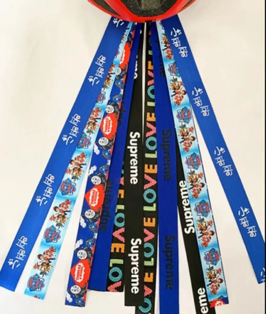 A decorative ribbon streamer for attaching to a child's roller skate or ski helmet, shown in a selection of colours.