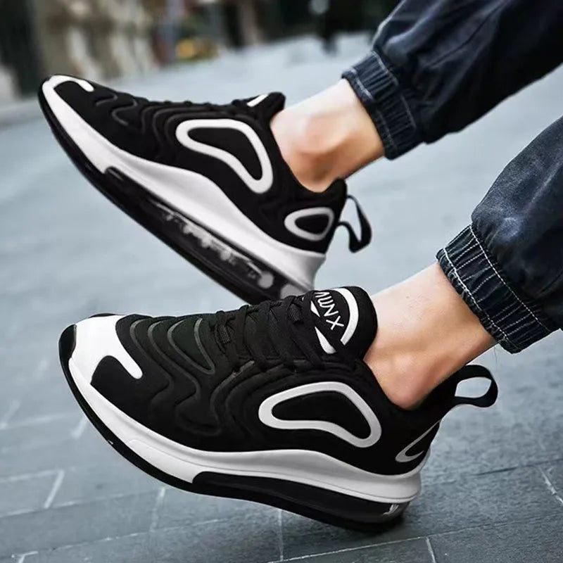 Men's black casual sneakers with lace-up front and thick sole.