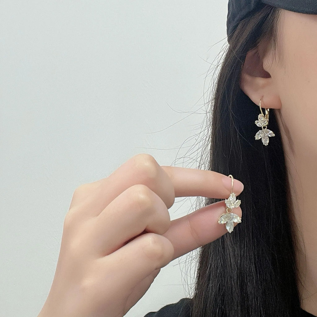 Platinum colour leaf-shaped earrings with inlaid zircon stones
