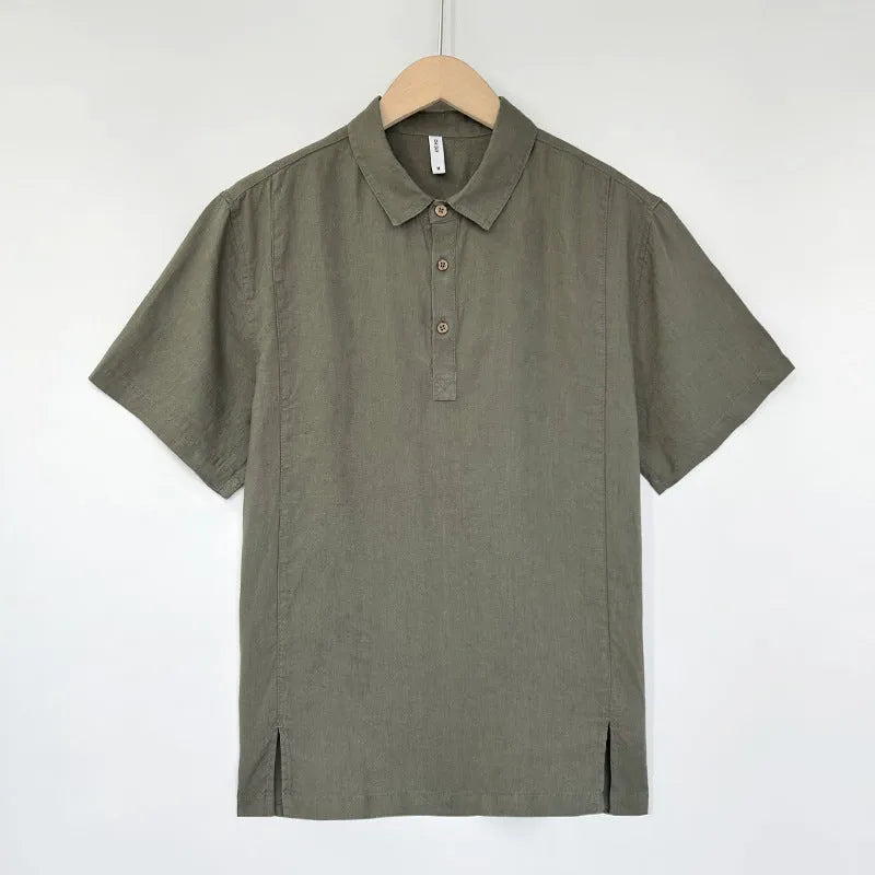 Man wearing a light grey-green linen short-sleeve top with thin lapels, showing loose fit.
