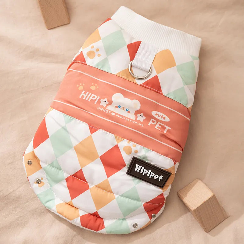 Quilted two-legged pet vest with leash ring in brown bear print or geometric red-green, sizes XS-XXL.