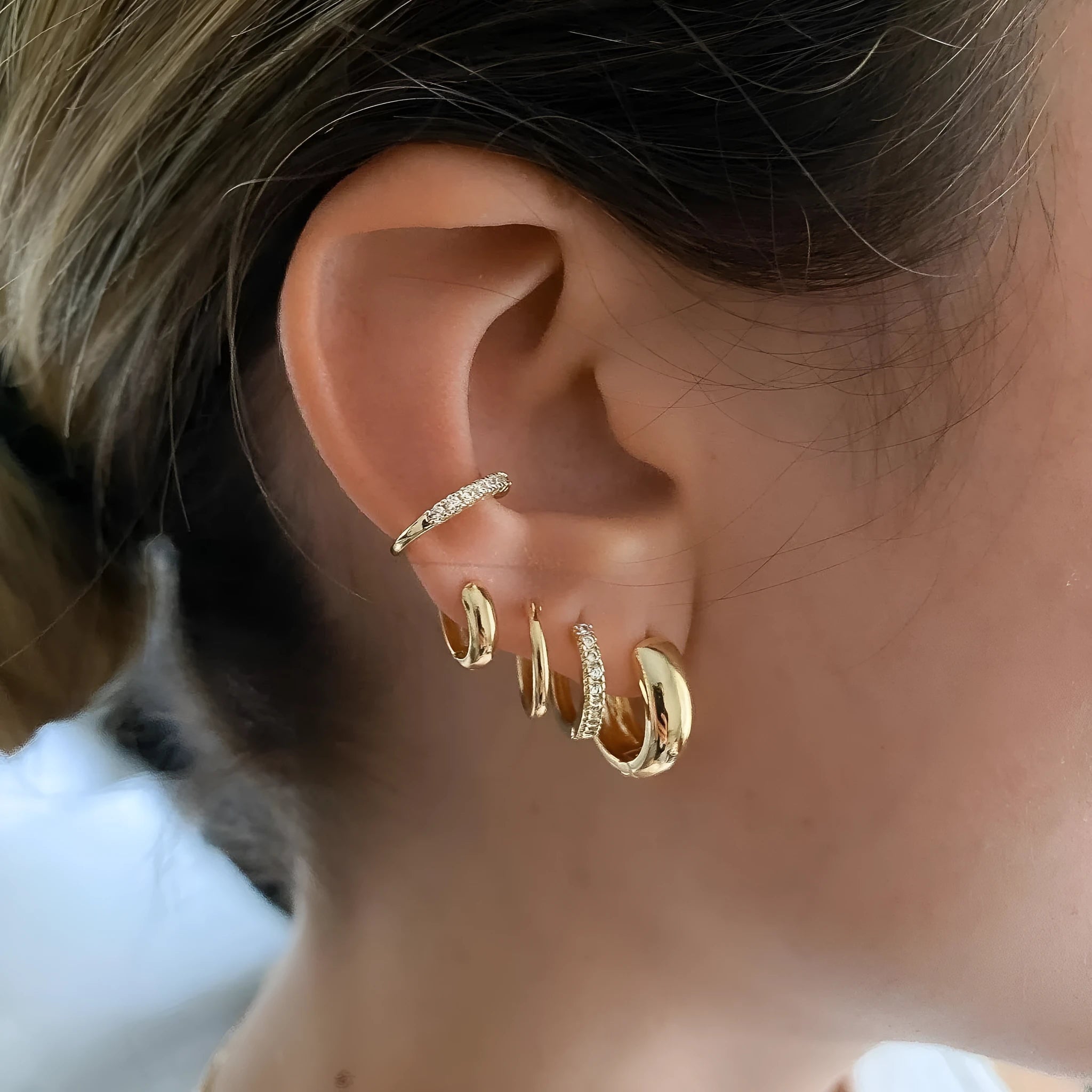 Five round copper earrings with inlaid zircon in gold and white gold colours