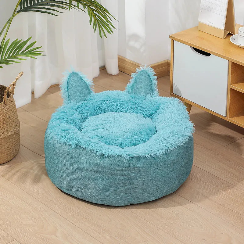 Round plush faux fur cat bed with raised sides in blue colour showing soft texture