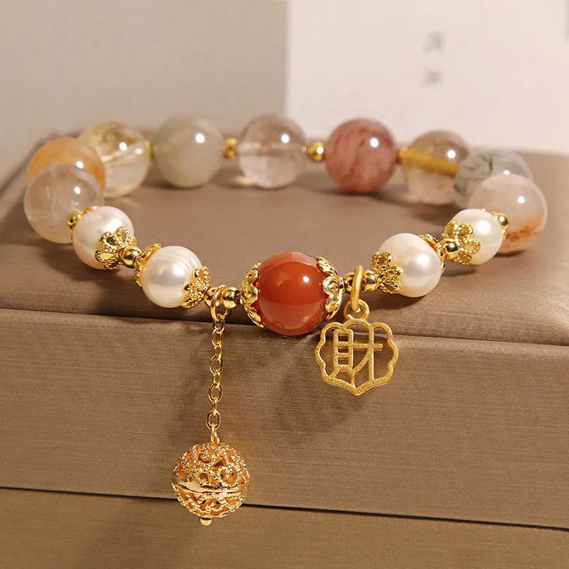 Women's Japanese-style crystal bracelet with pearls and Chinese 'Cai' character charm.
