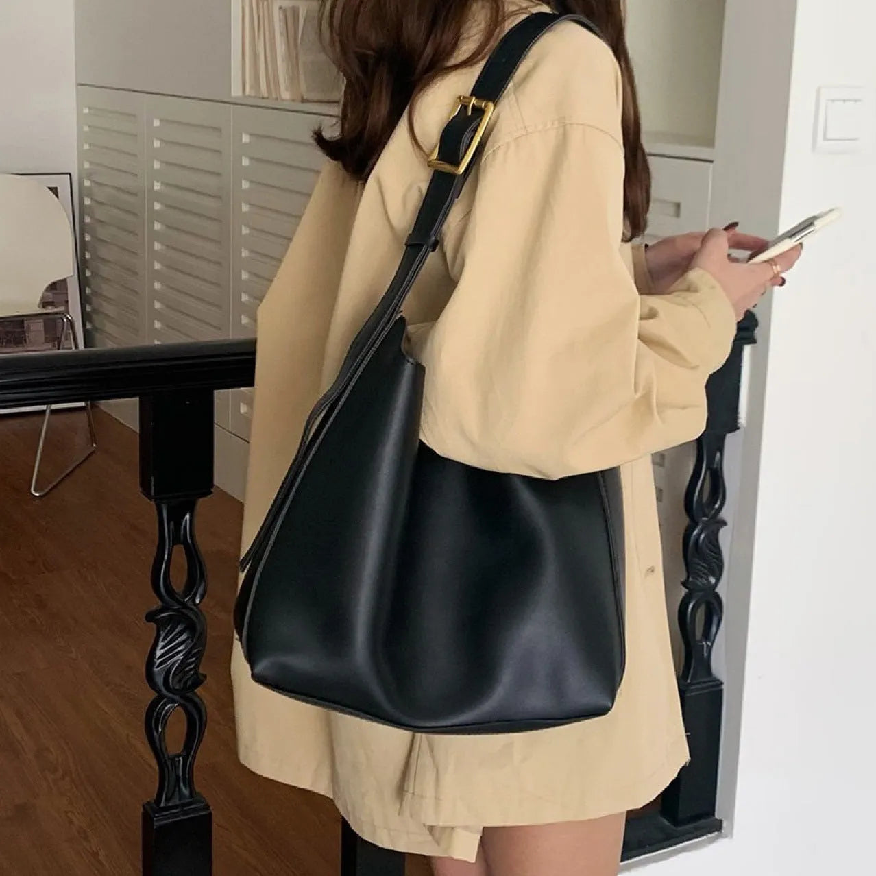 Women's soft PU shoulder bag with tassel detail in black and brown colour options