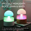 White cloud-shaped humidifier and aroma diffuser with coloured lights and simulated rain.