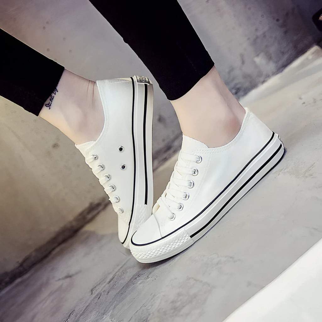 Women's solid colour canvas casual shoes in multiple colour options on a white background.