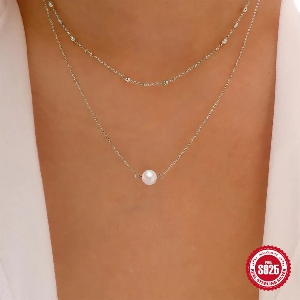 S925 Sterling silver double layer necklace with twin pearls on a ball bead chain, shown in gold and white gold colours.
