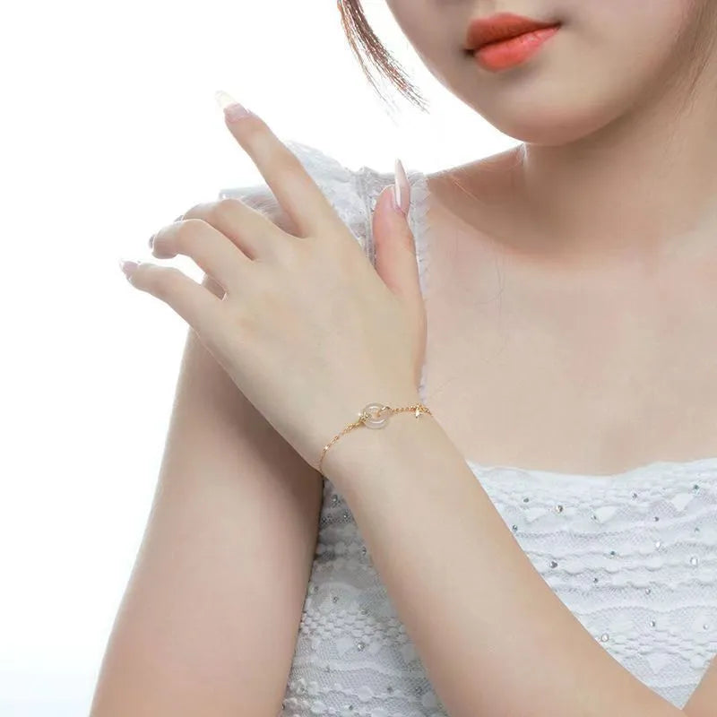 Silver bracelet with white chalcedony stone and starry sky patterned gold peace buckle.
