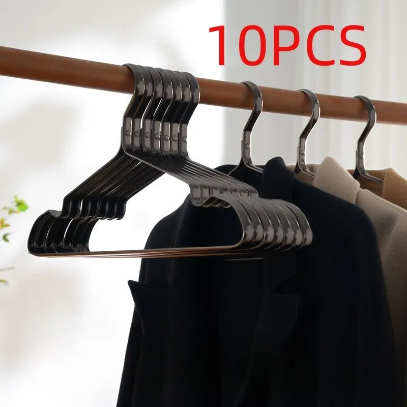 Elegant black non-slip clothes hanger for shirts, trousers and ties on a rail.